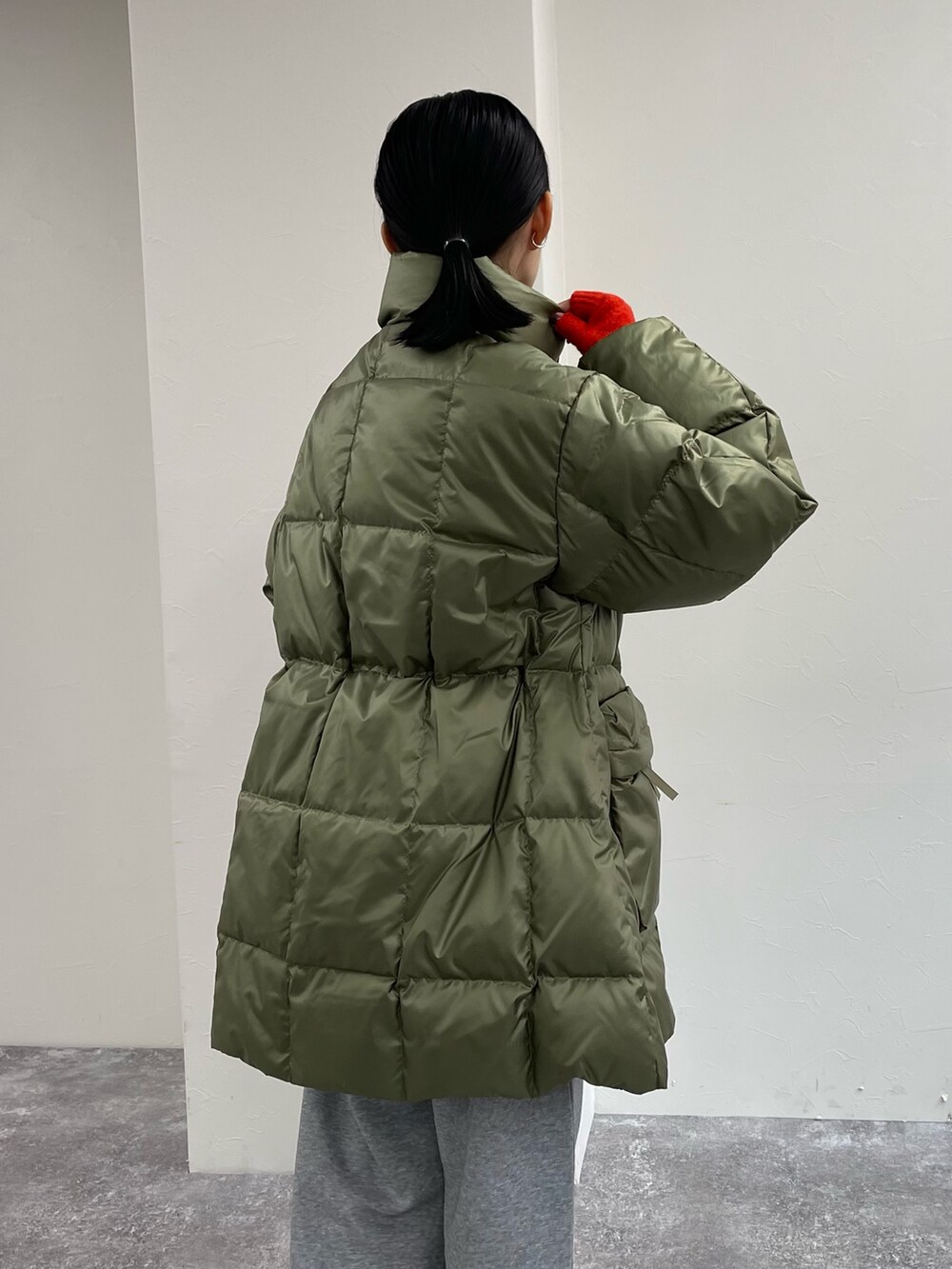 グリーン系のダウンジャケット/コート、グレー系のスウェットパンツ、ベージュ系のブーツを着用したレディースの秋コーディネートの6枚目の写真