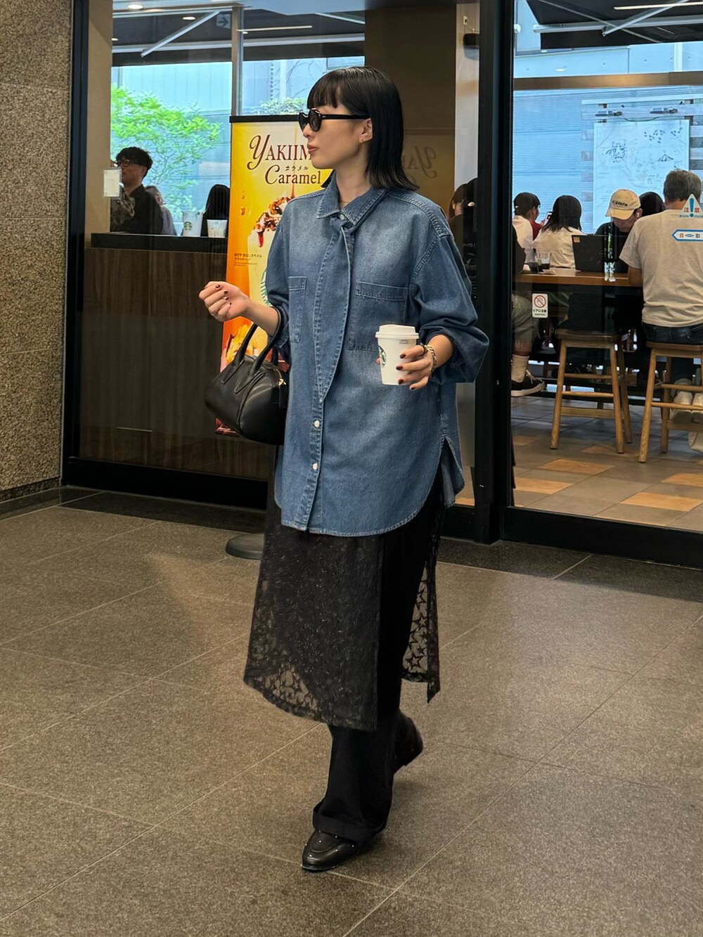 ブルー系のシャツ/ブラウス、ブルー系のチノパンツ、ブラック系のスカートを着用したレディースの秋コーディネートの2枚目の写真