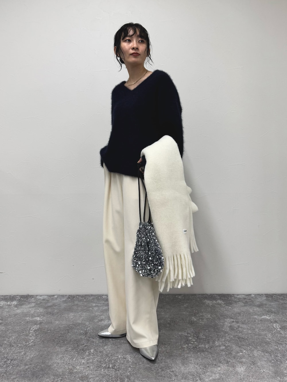 ブルー系のニット/セーター、ホワイト系のその他パンツ、ホワイト系のストール/ショールを着用したレディースの冬コーディネートの3枚目の写真