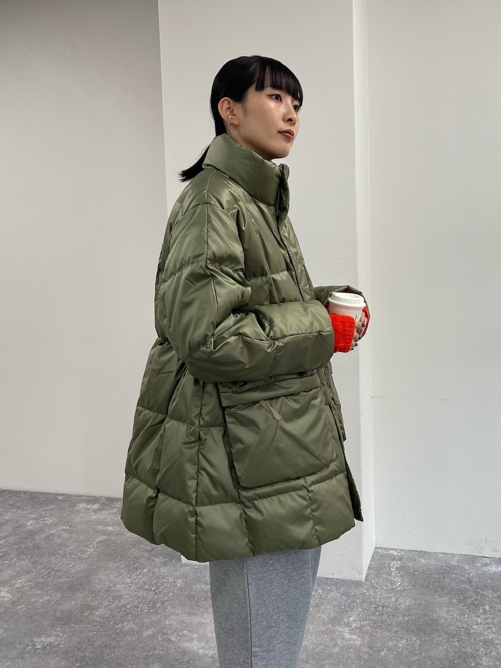 グリーン系のダウンジャケット/コート、グレー系のスウェットパンツ、ベージュ系のブーツを着用したレディースの秋コーディネートの5枚目の写真