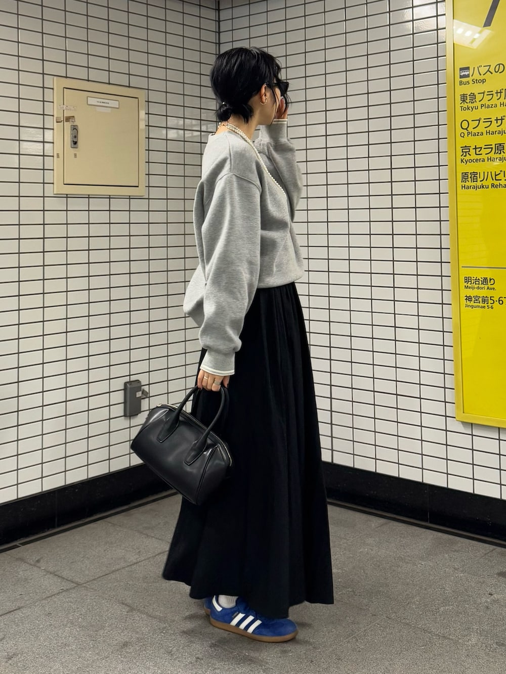 グレー系のスウェット、ブラック系のスカートを着用したレディースの冬コーディネートの5枚目の写真