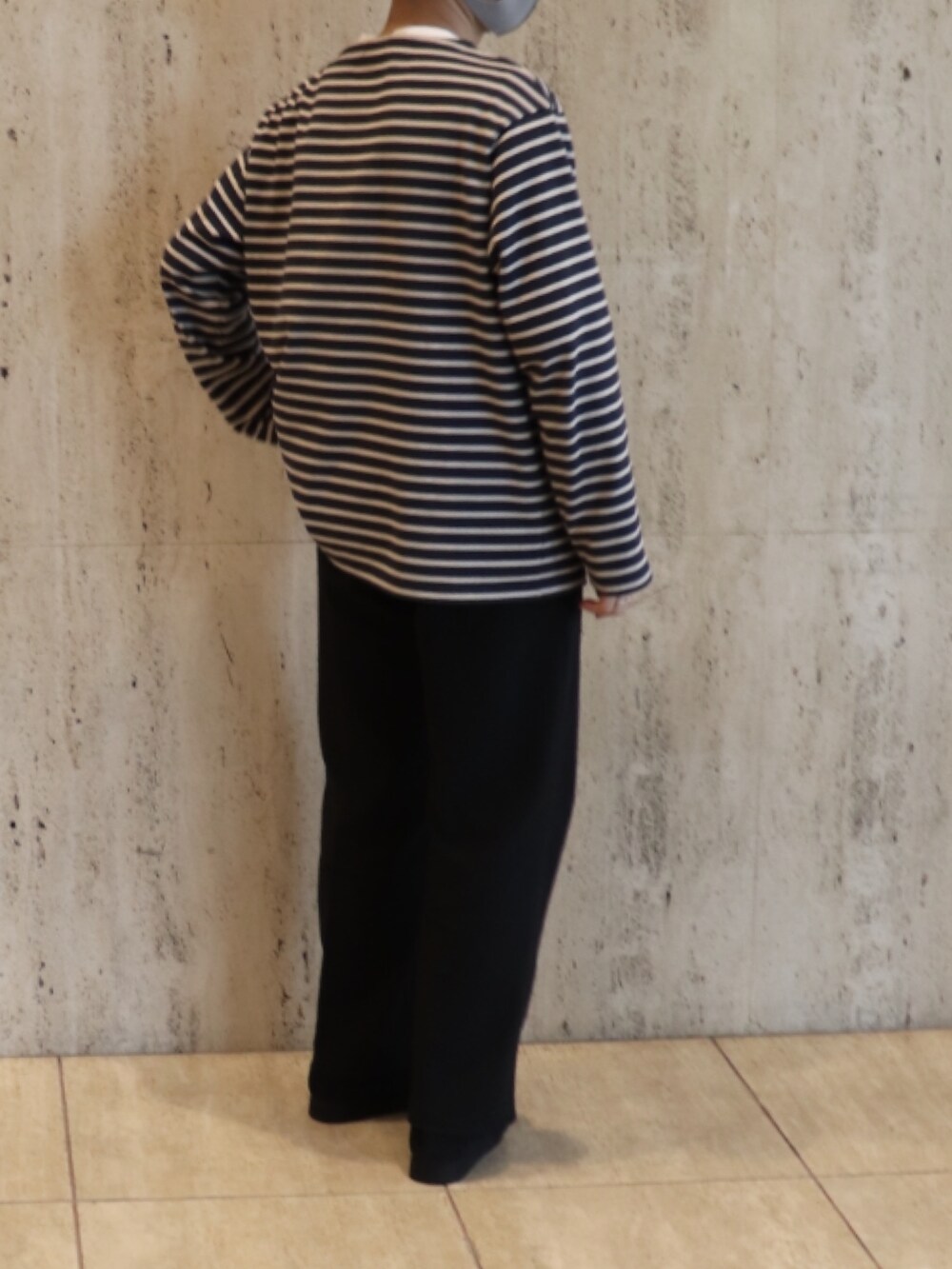 ブルー系のTシャツ/カットソー、ブラック系のスラックス、ブラック系のモカシン/デッキシューズを着用したメンズの冬コーディネートの2枚目の写真