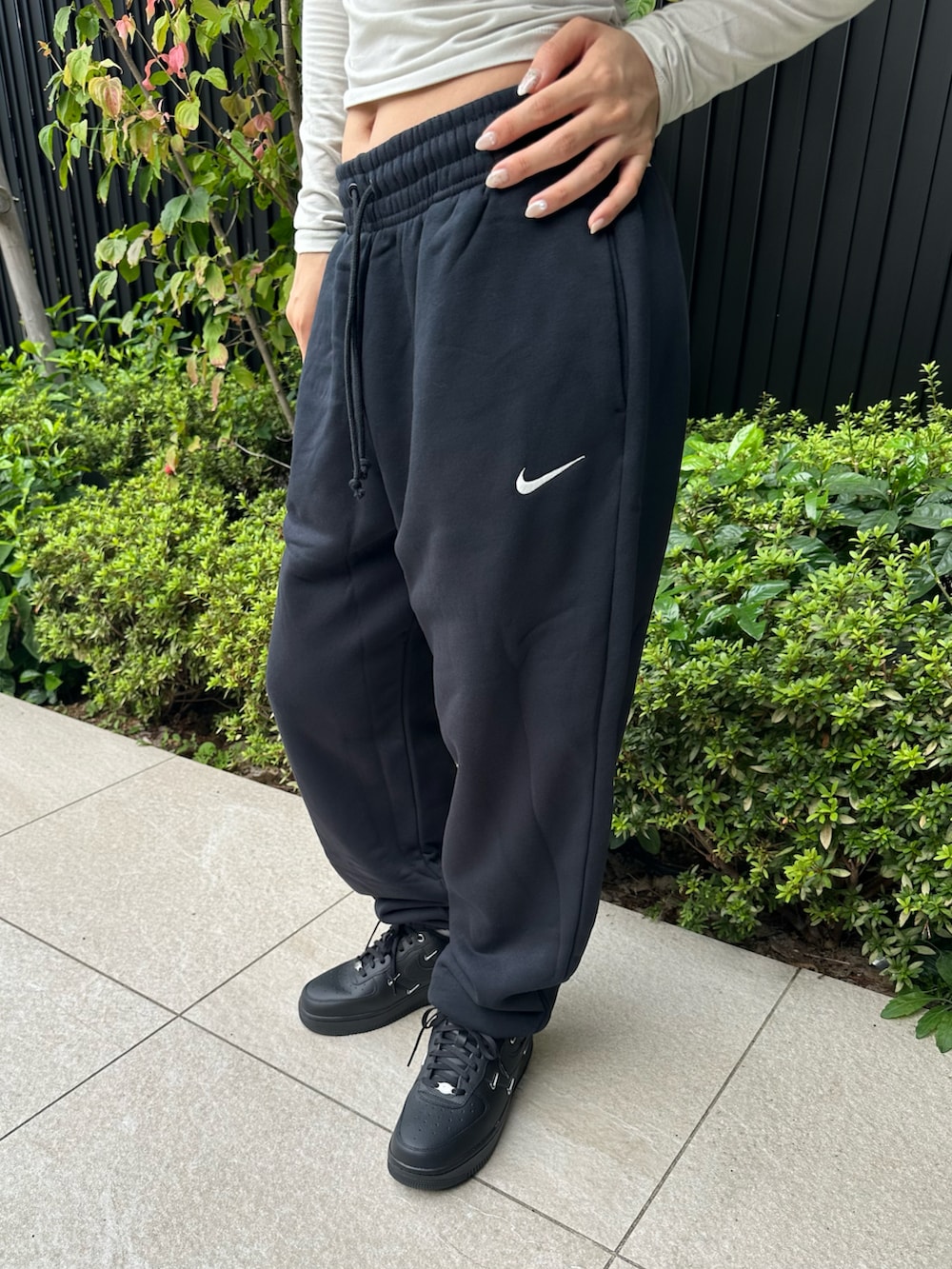 ブラック系のスニーカー、ブラック系のパーカー、ブラック系のスウェットパンツを着用したレディースの秋コーディネートの3枚目の写真