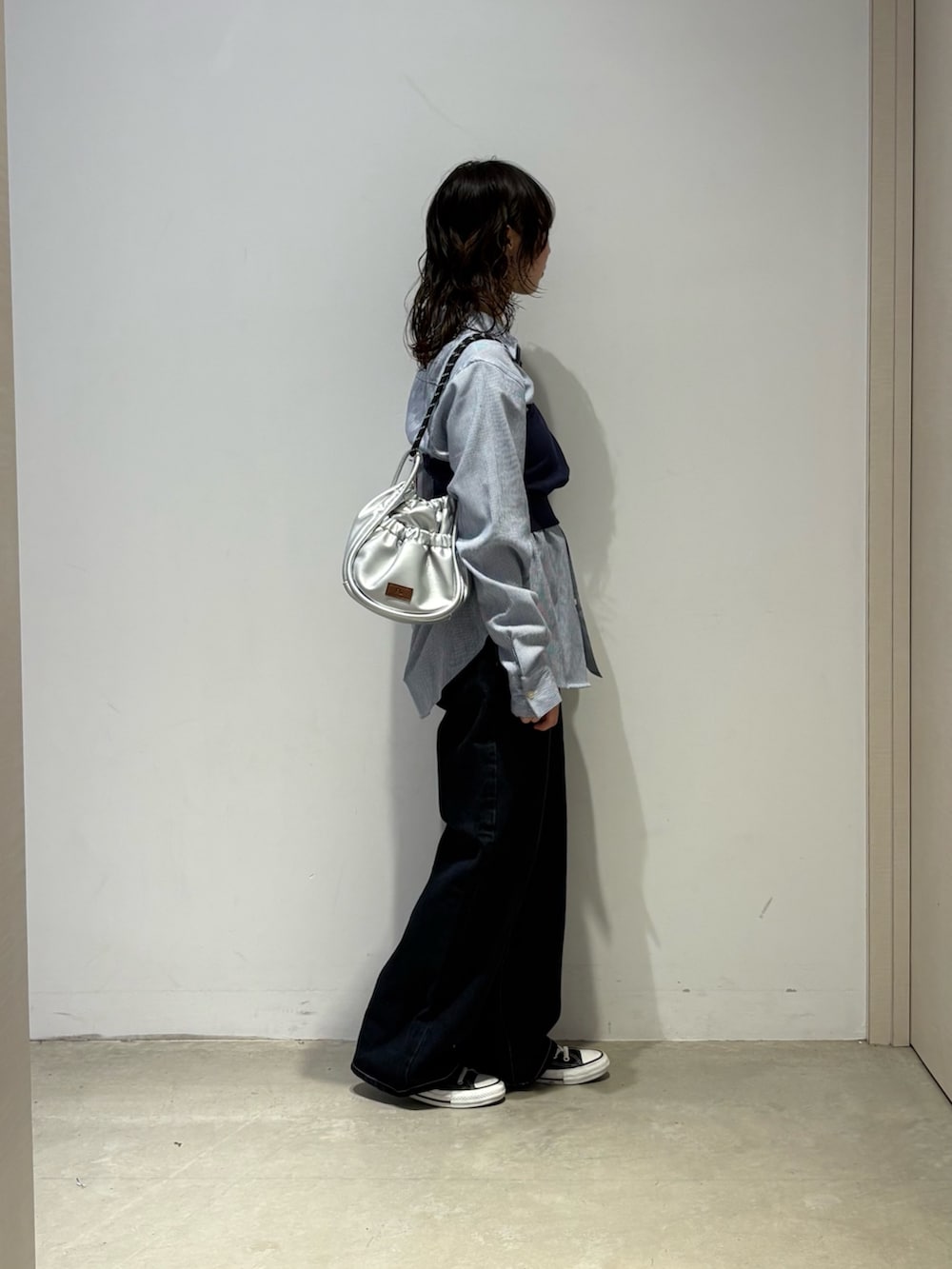 ブルー系のシャツ/ブラウス、ブルー系のデニムパンツ、シルバー系のショルダーバッグを着用したレディースの春コーディネートの4枚目の写真