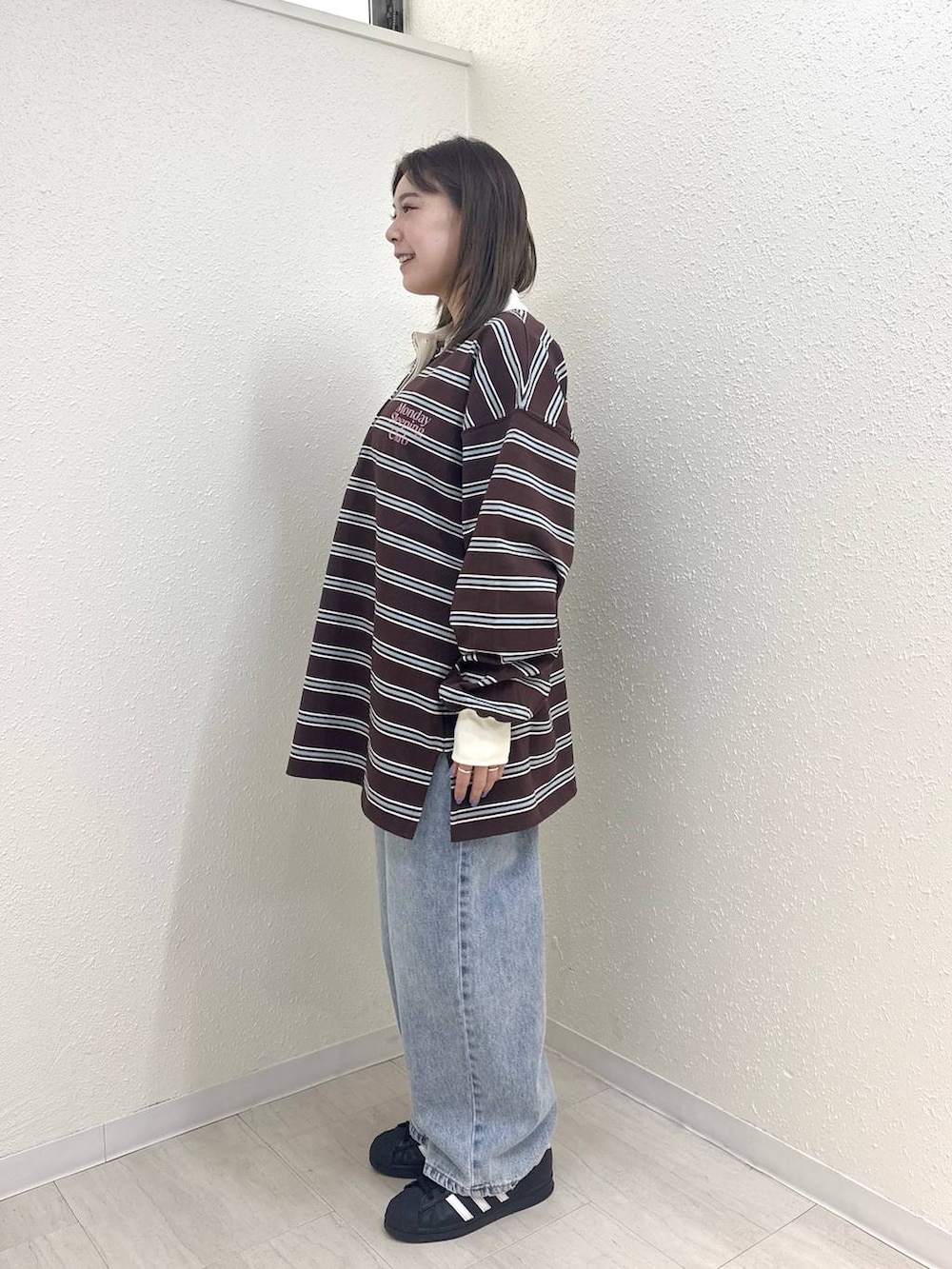 ブルー系のデニムパンツ、ブラウン系のTシャツ/カットソーを着用したレディースの春コーディネートの3枚目の写真