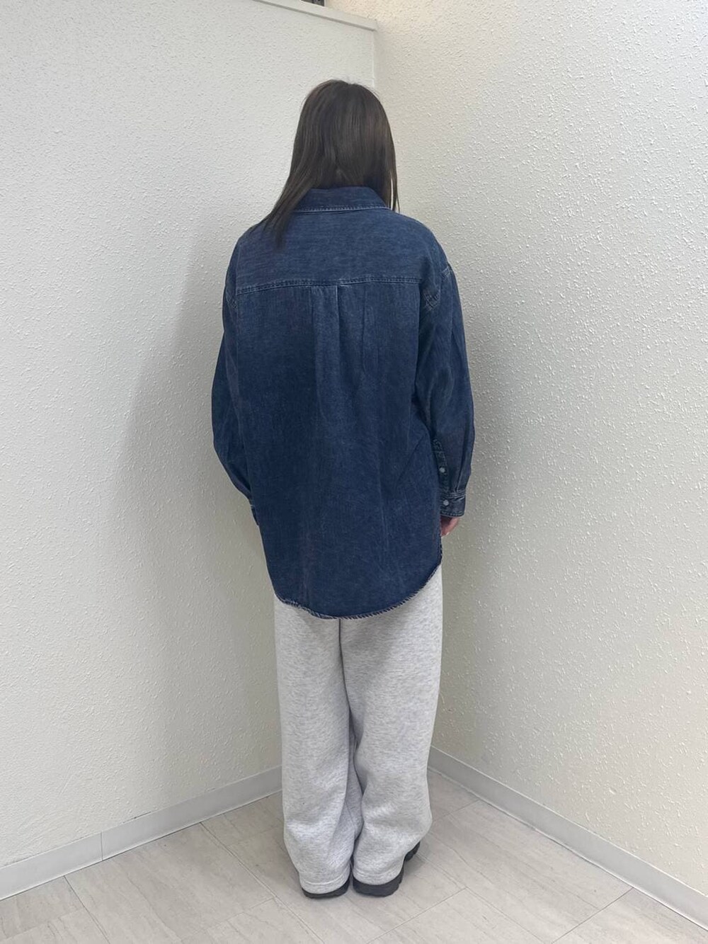 グレー系のスウェットパンツ、ブルー系のシャツ/ブラウス、ブラウン系のローファーを着用したレディースの冬コーディネートの4枚目の写真