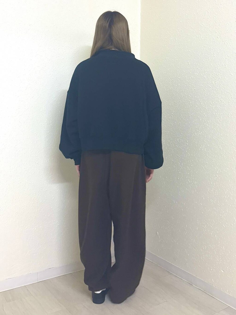 ブラウン系のその他パンツ、ブラック系のスウェット、ホワイト系のTシャツ/カットソーを着用したレディースの秋コーディネートの3枚目の写真