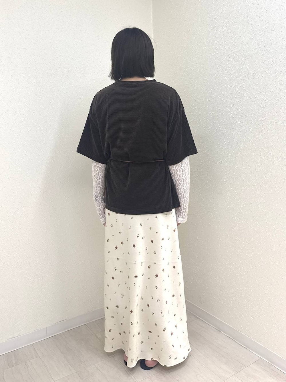 イエロー系のボディバッグ/ウエストポーチ、ブラウン系のTシャツ/カットソー、ホワイト系のスカートを着用したレディースの秋コーディネートの2枚目の写真