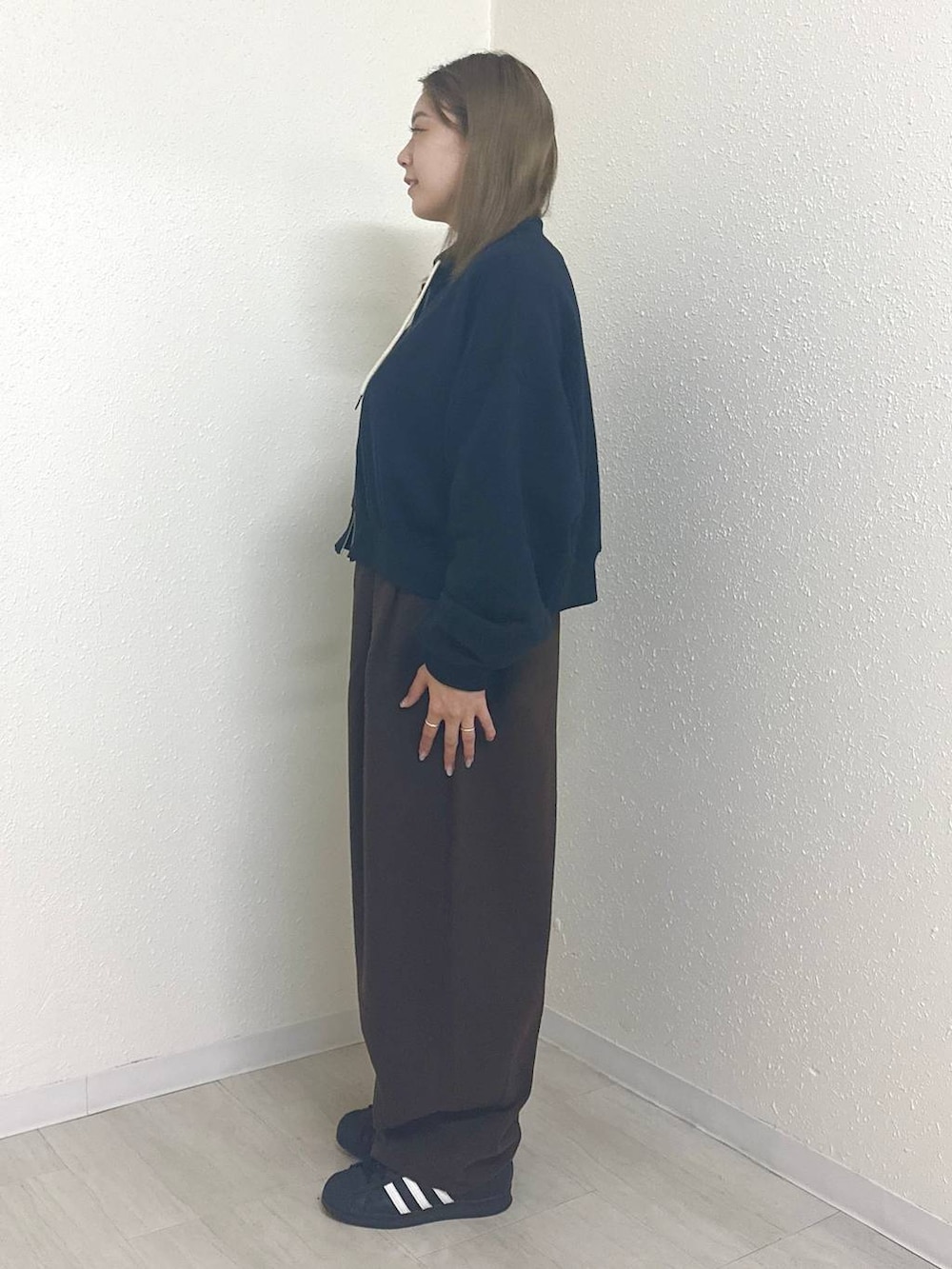 ブラウン系のその他パンツ、ブラック系のスウェット、ホワイト系のTシャツ/カットソーを着用したレディースの秋コーディネートの2枚目の写真