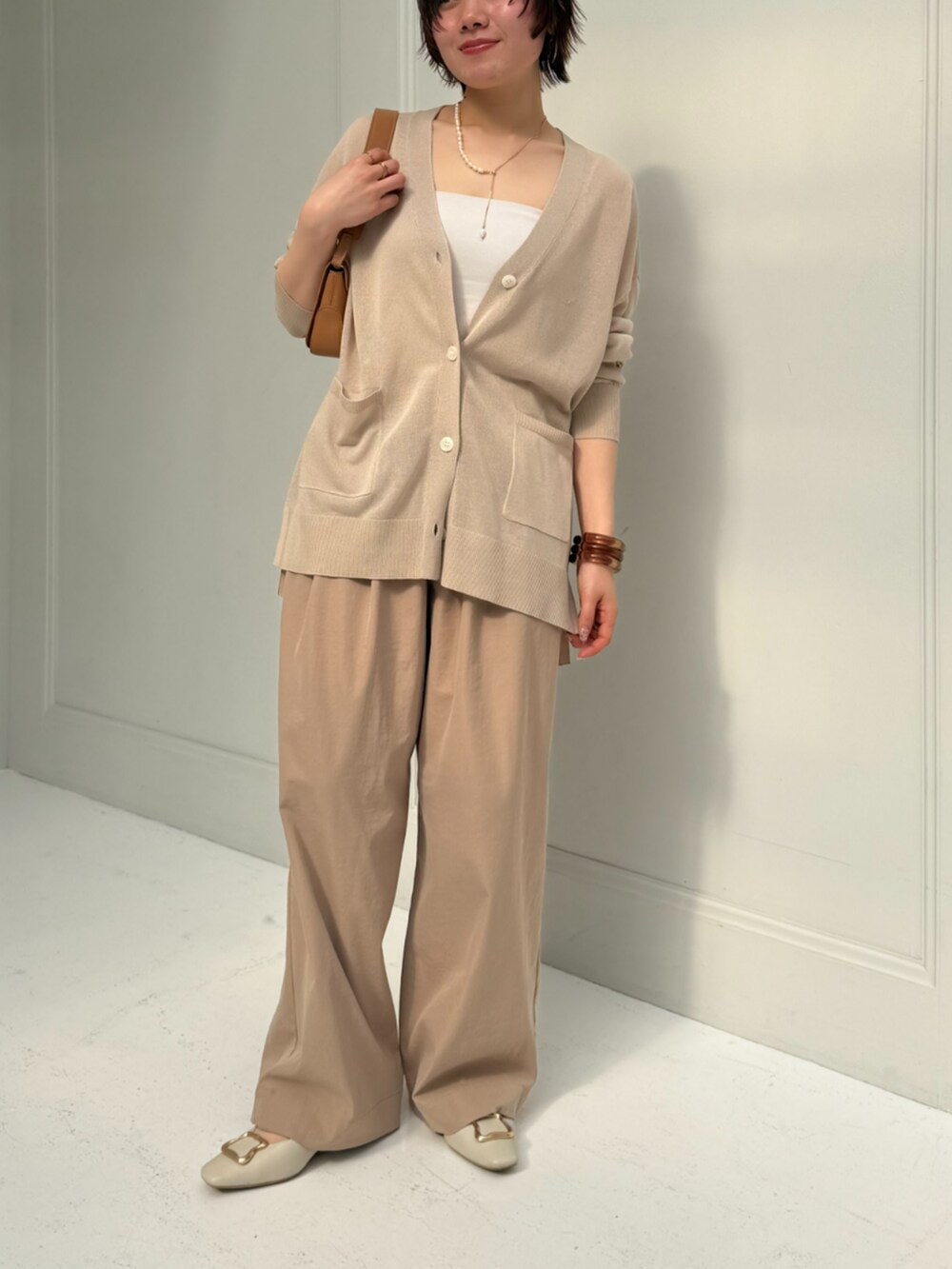 ベージュ系のカーディガン/ボレロ、ベージュ系のその他パンツを着用したレディースの春コーディネートの2枚目の写真