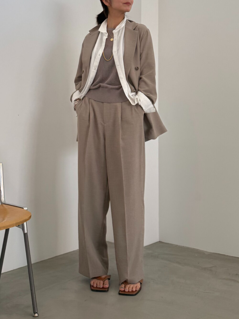 ブラウン系のスラックス、ブラウン系のテーラードジャケット、ホワイト系のシャツ/ブラウスを着用したレディースの春コーディネートの2枚目の写真