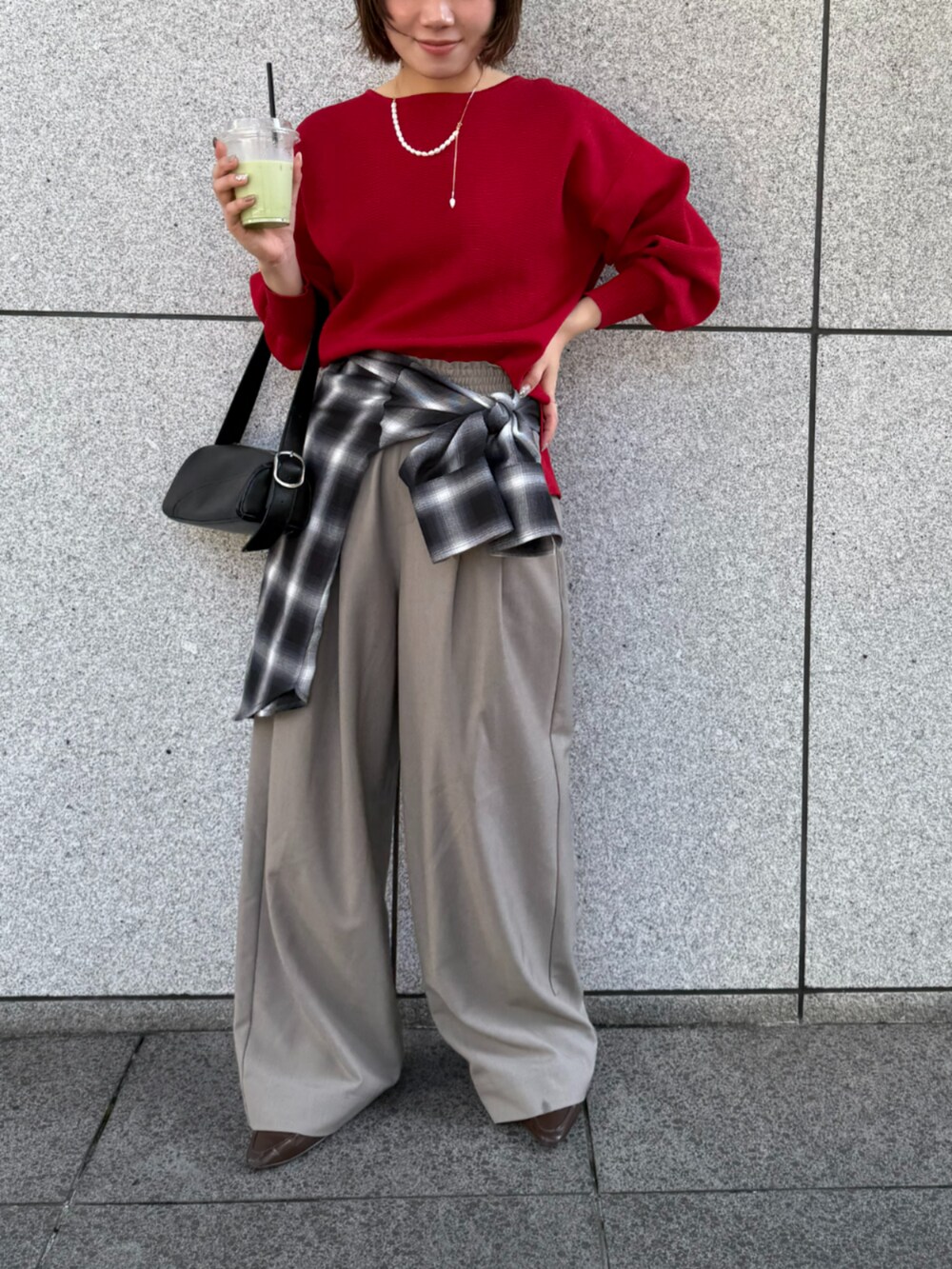 ベージュ系のスラックス、ブラック系のシャツ/ブラウス、レッド系のニット/セーターを着用したレディースの秋コーディネートの2枚目の写真