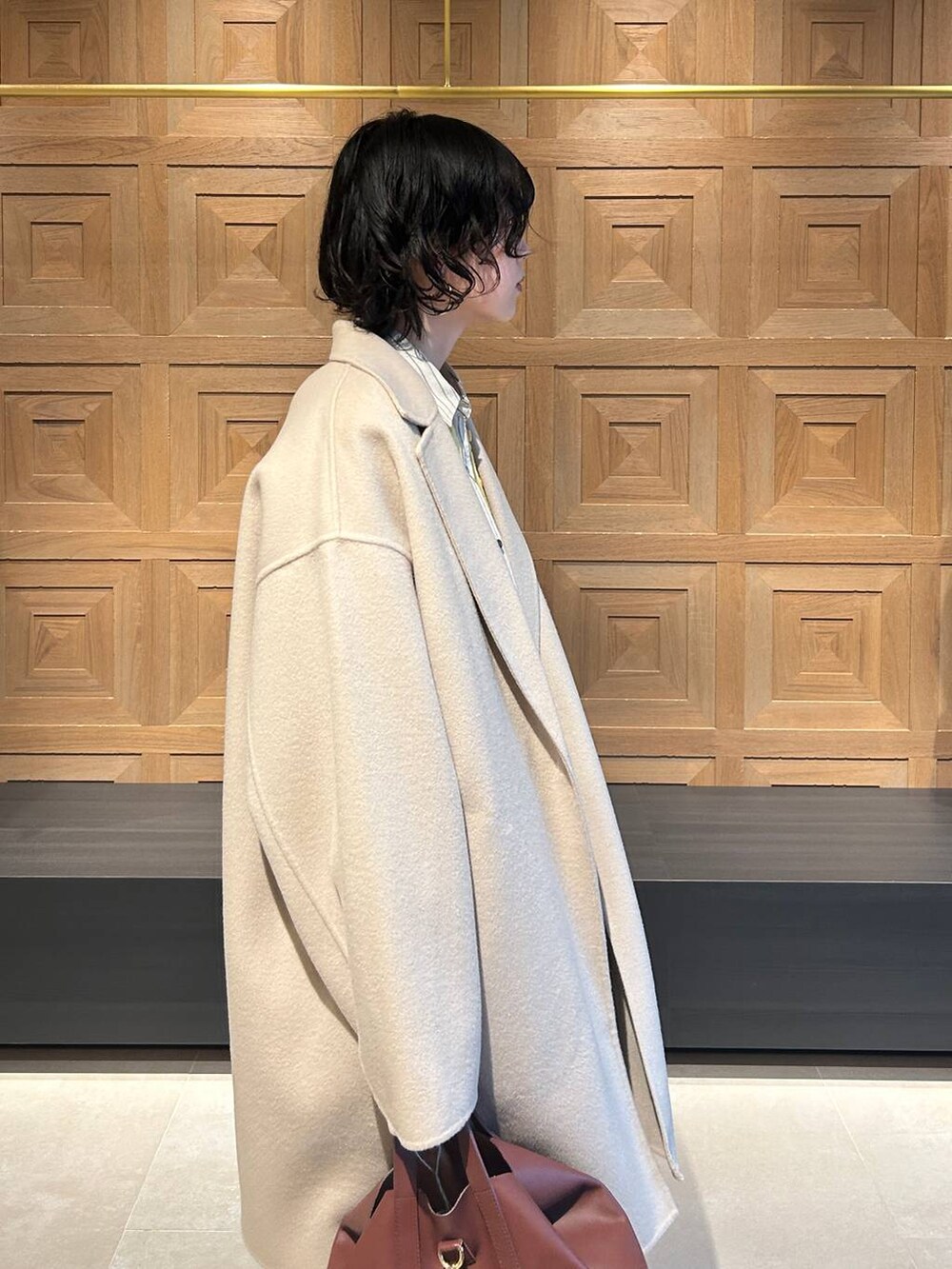 ブラウン系のショルダーバッグ、ベージュ系のその他パンツ、ホワイト系のシャツ/ブラウスを着用したレディースの秋コーディネートの6枚目の写真