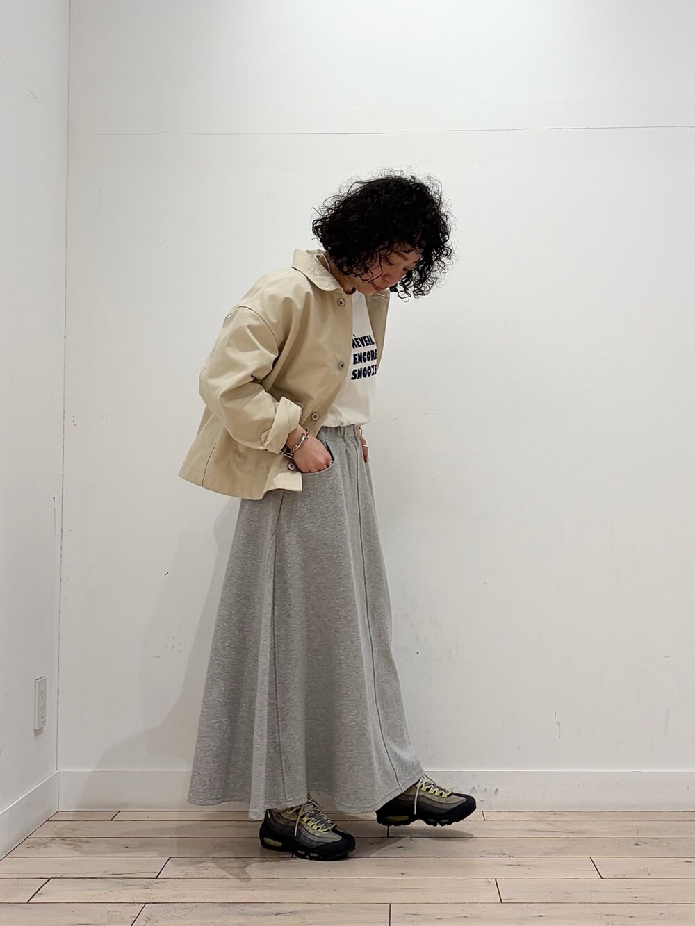 グレー系のスカート、その他のTシャツ/カットソー、ホワイト系のカバーオールを着用したレディースの春コーディネートの5枚目の写真