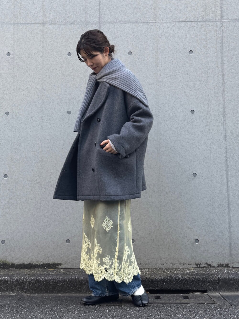 グレー系のピーコート、グレー系のニット/セーターを着用したレディースの冬コーディネートの2枚目の写真