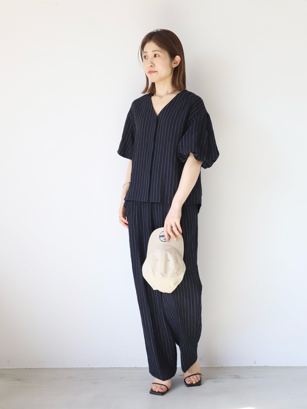 「mica&deal、マイカアンドディール、セットアップ、ストライプ、パフスリーブ、キャップ、NEWERA、大人カジュアル、リネンパンツ、イージーパンツ、30代コーデ、おでかけコーデ、タックパンツ、きれいめカジュアル、シンプルスタイル」｜「NEW ERAの【NEW ERA×MICA&DEAL】コラボレーション撥水CAP（キャップ、ベージュ系）」を使った、erikaさん（レディース・163cm）の夏コーディネートの3枚目の写真