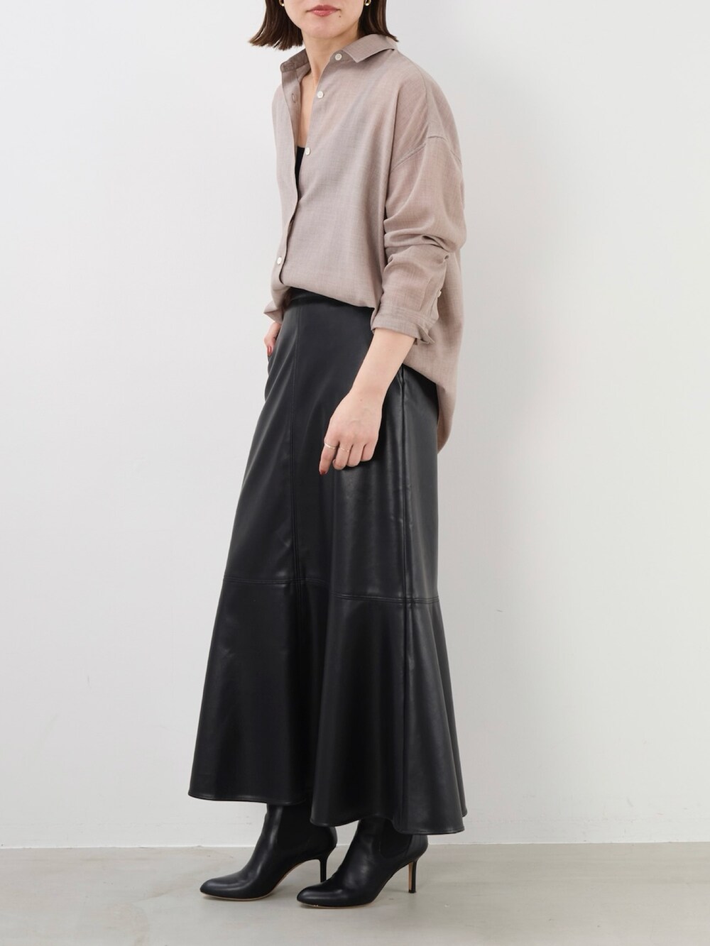 ブラック系のスカート、ベージュ系のシャツ/ブラウスを着用したレディースの秋コーディネートの4枚目の写真