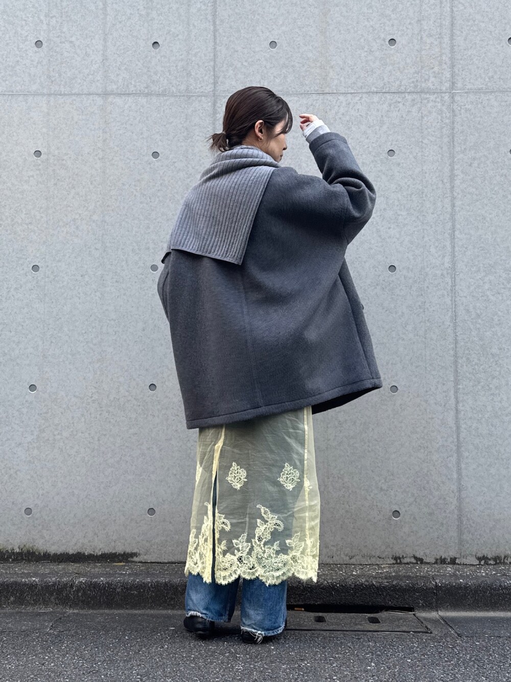 グレー系のピーコート、グレー系のニット/セーターを着用したレディースの冬コーディネートの3枚目の写真