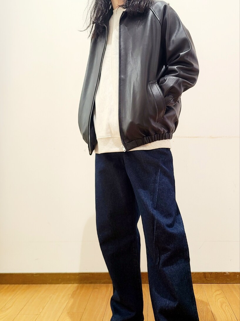 ブラック系のライダースジャケット、ブルー系のデニムパンツを着用したメンズの冬コーディネートの4枚目の写真