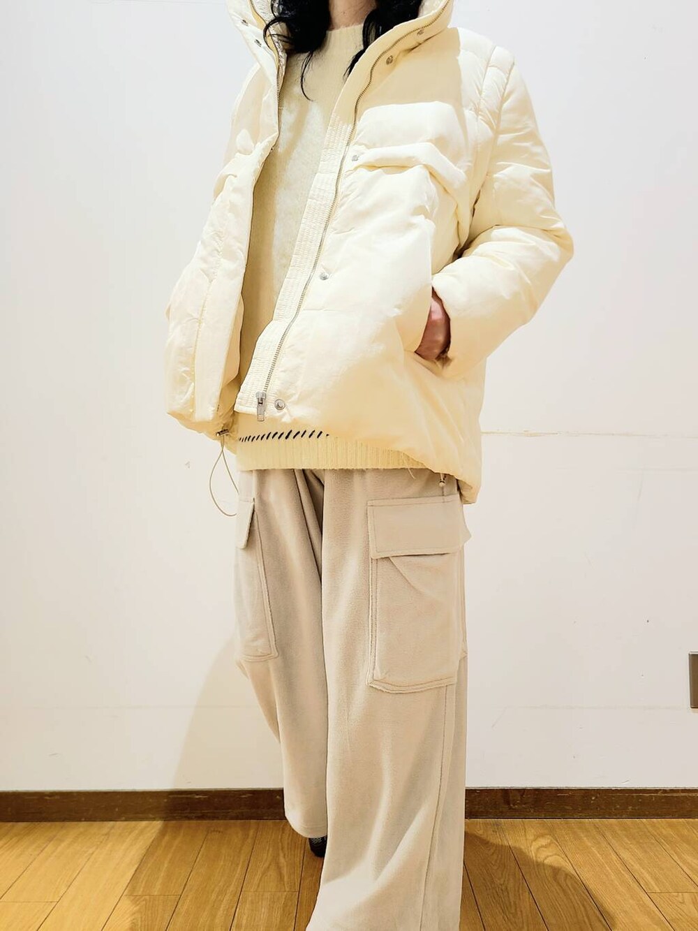 ホワイト系のダウンジャケット/コート、ホワイト系のニット/セーター、グレー系のその他パンツを着用したメンズの冬コーディネートの4枚目の写真