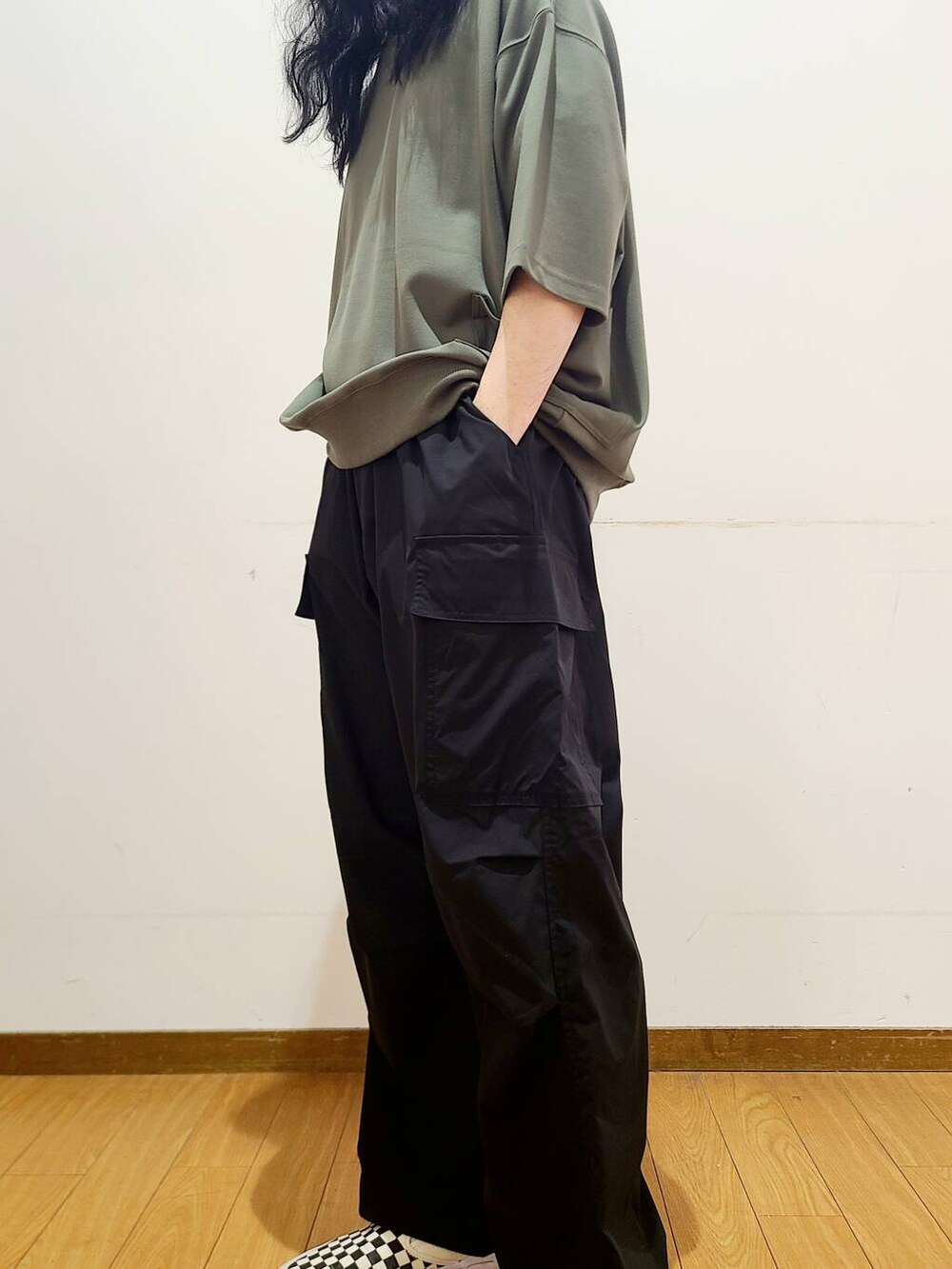 ブラック系のスニーカー、ブラック系のその他パンツ、グリーン系のTシャツ/カットソーを着用したメンズの春コーディネートの5枚目の写真