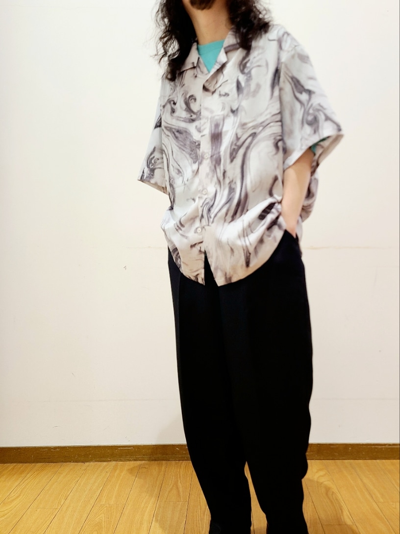 グリーン系のTシャツ/カットソー、ブラック系のスラックス、ホワイト系のシャツ/ブラウスを着用したメンズの夏コーディネートの4枚目の写真
