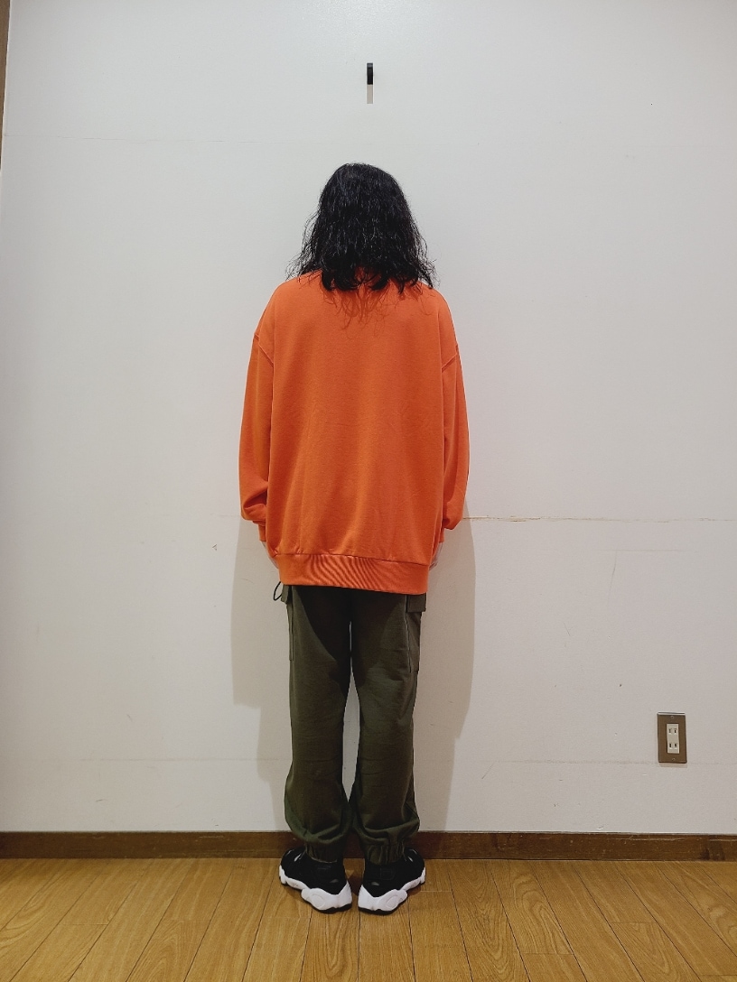 オレンジ系のスウェット、グリーン系のスウェットパンツを着用したメンズの秋コーディネートの4枚目の写真