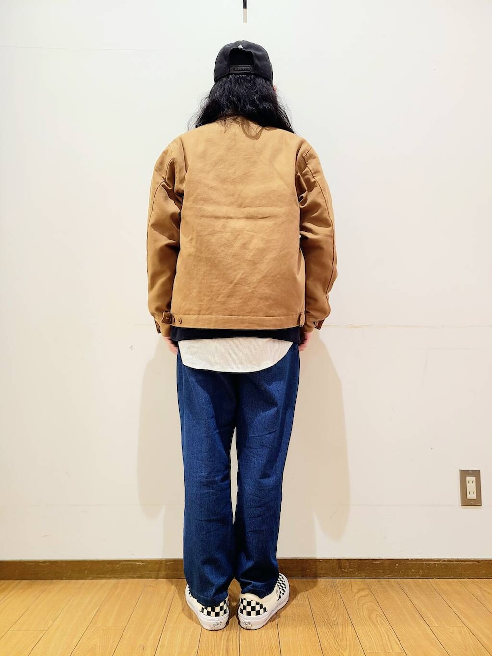 イエロー系のその他アウター、ブラック系のスニーカー、ブルー系のその他パンツを着用したメンズの冬コーディネートの3枚目の写真