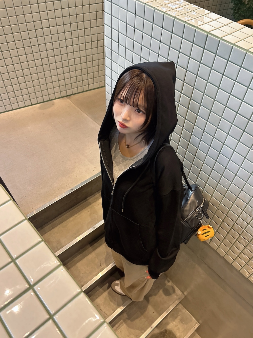 ホワイト系のスニーカーを着用したレディースの秋コーディネートの2枚目の写真