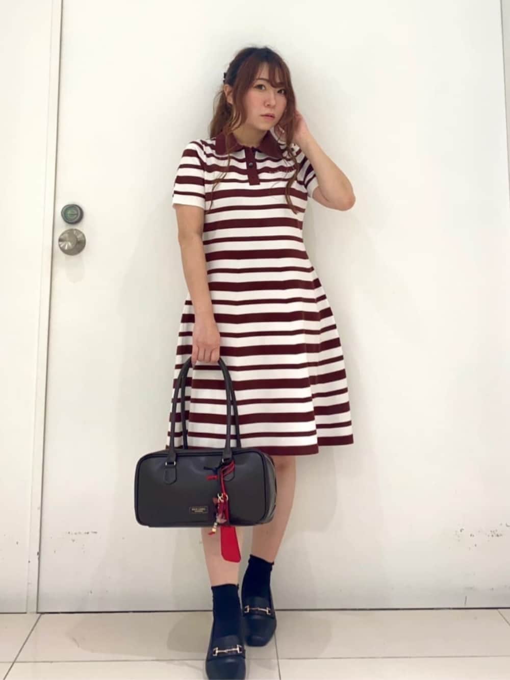 ブラウン系のボストンバッグ、レッド系のワンピース、レッド系のキーケース/キーアクセサリーを着用したレディースの夏コーディネートの2枚目の写真