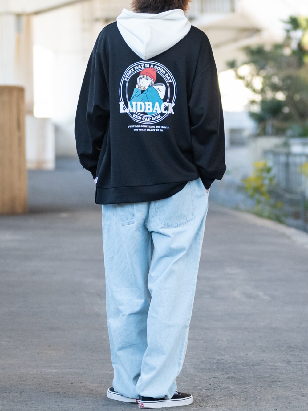 ブラック系のパーカー、ブルー系のデニムパンツ、ブラック系のスニーカーを着用したメンズの冬コーディネートの3枚目の写真