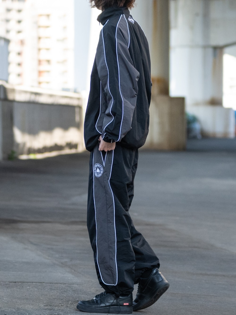 ブラック系のその他パンツ、ブラック系のナイロンジャケットを着用したメンズの冬コーディネートの2枚目の写真