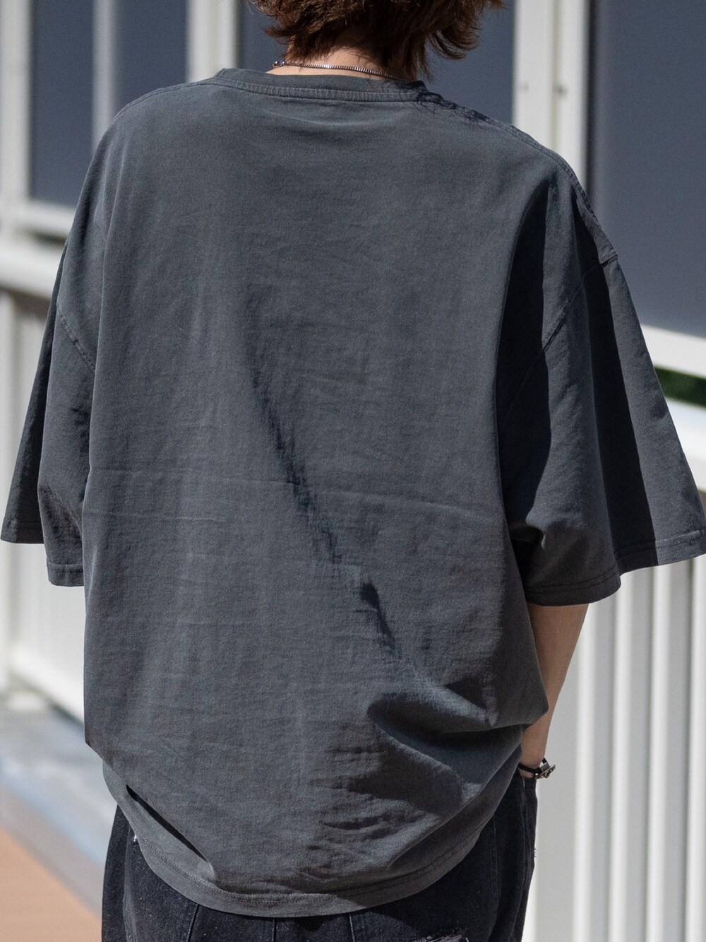 ブラック系のデニムパンツ、グレー系のTシャツ/カットソーを着用したメンズの春コーディネートの4枚目の写真