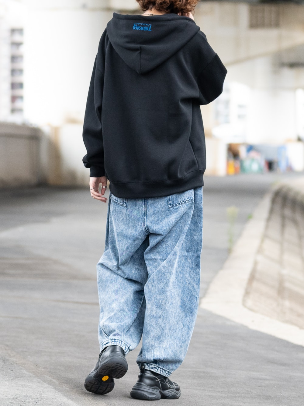 ブルー系のデニムパンツ、ブラック系のパーカーを着用したメンズの秋コーディネートの3枚目の写真