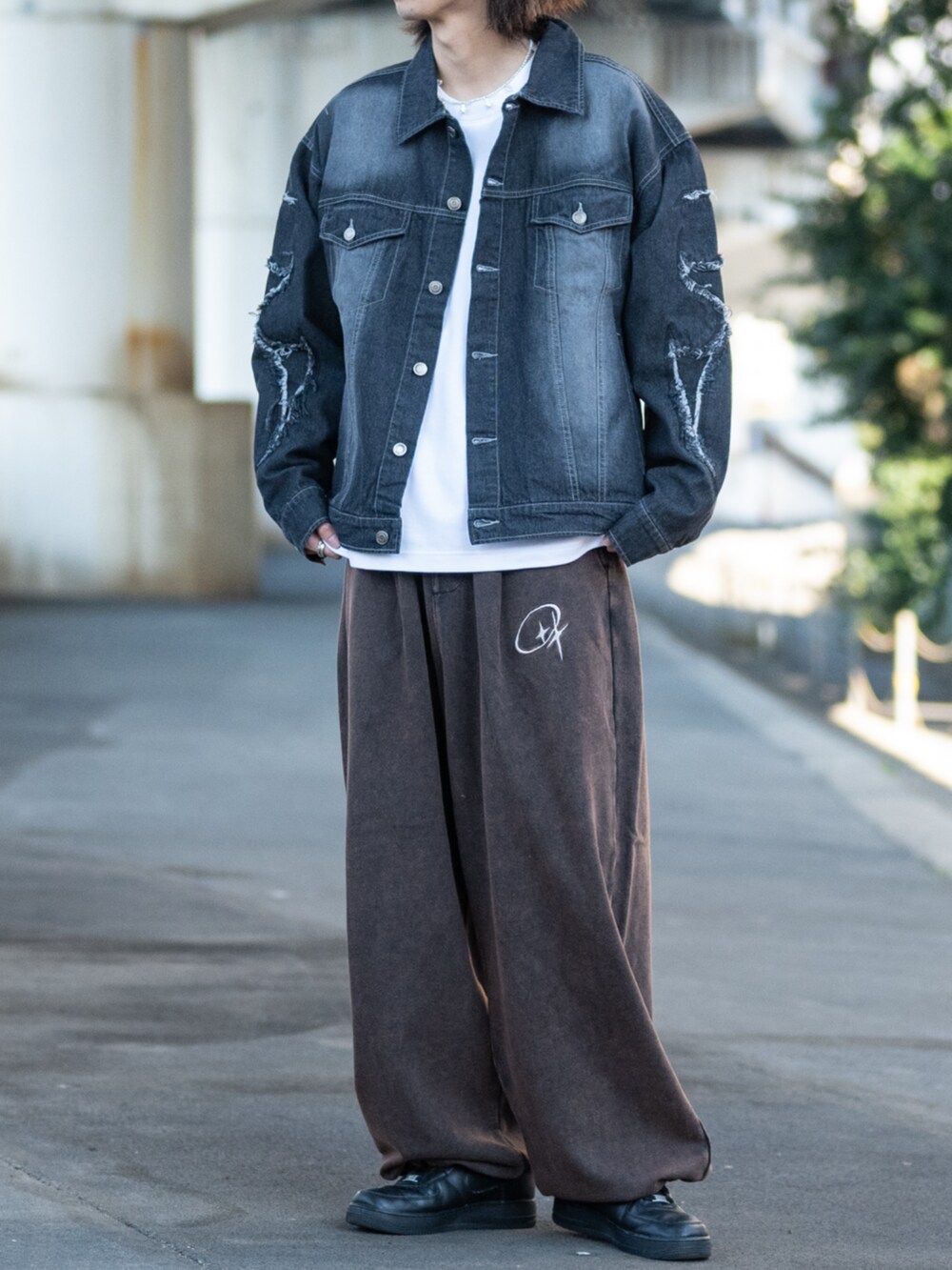 ブラック系のスニーカー、ホワイト系のスウェットパンツ、ブラック系のデニムジャケットを着用したメンズの春コーディネートの3枚目の写真