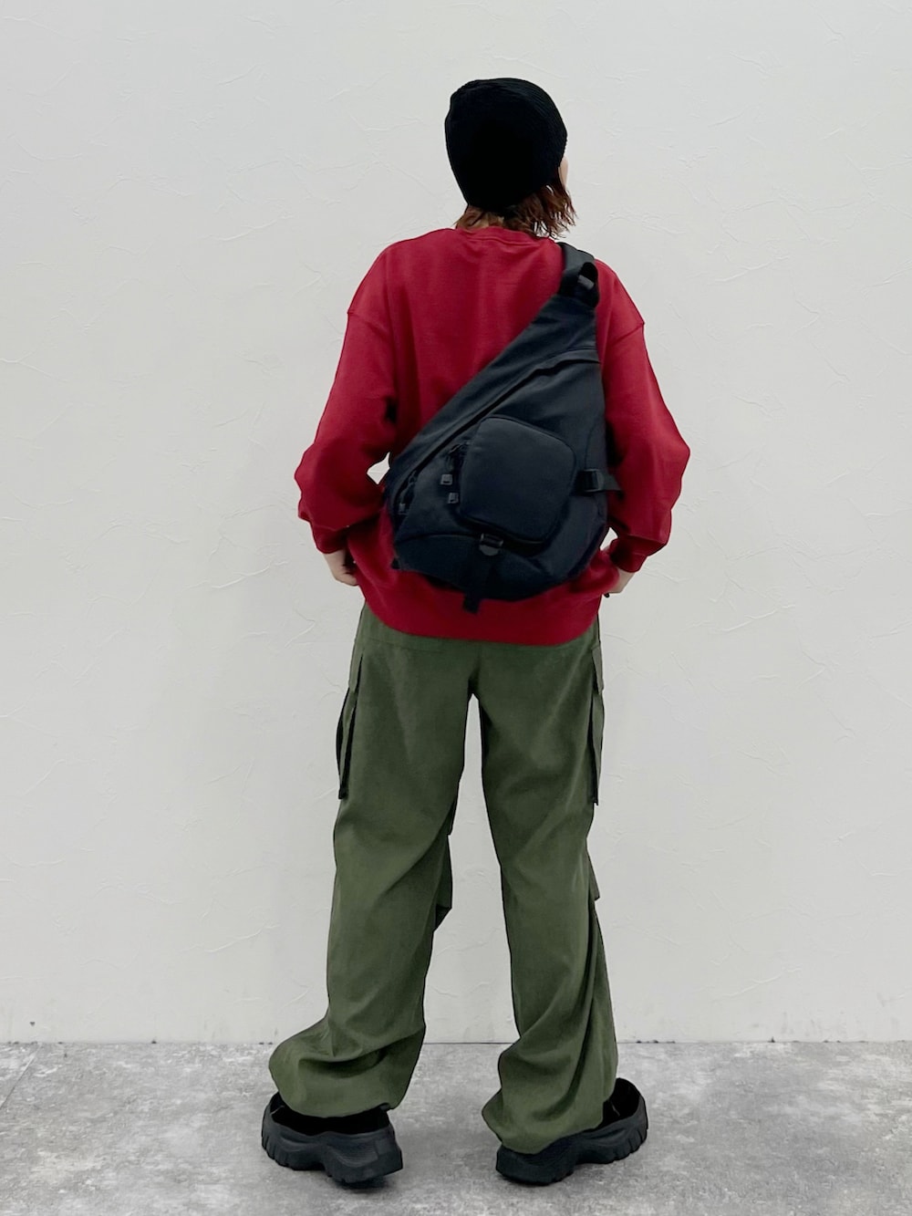 グリーン系のカーゴパンツ、レッド系のスウェット、ブラック系のニットキャップ/ビーニーを着用したレディースの秋コーディネートの4枚目の写真