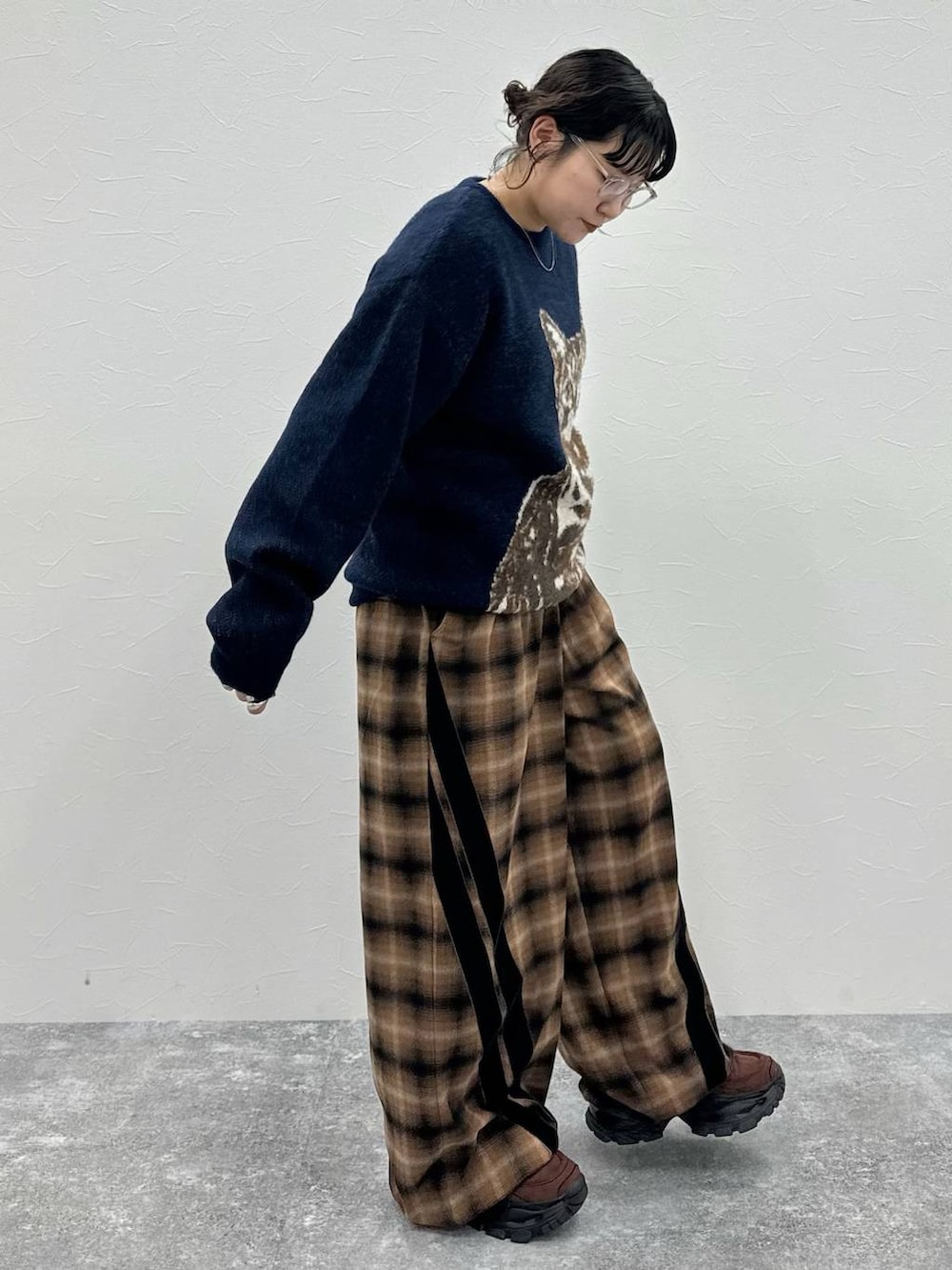 ブラウン系のローファー、ブラウン系のスラックス、ブルー系のニット/セーターを着用したレディースの秋コーディネートの2枚目の写真