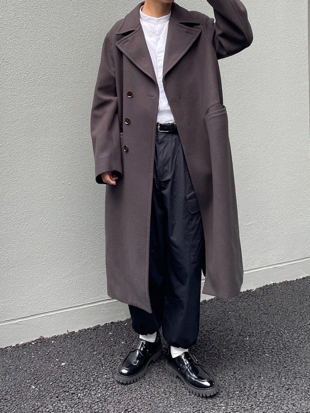 ホワイト系のシャツ/ブラウス、グレー系のチェスターコート、ブラック系のカーゴパンツを着用したメンズの秋コーディネートの2枚目の写真