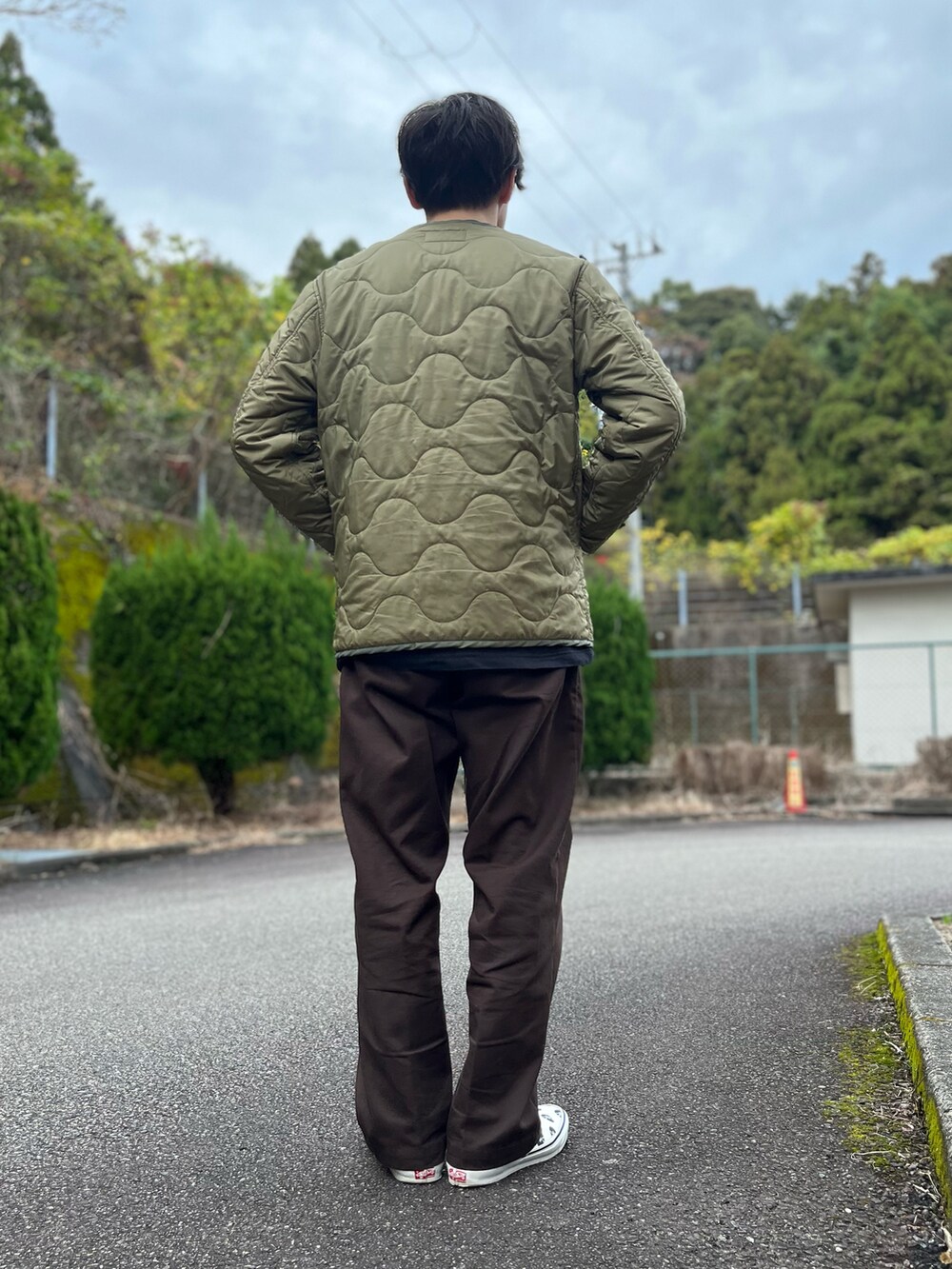 ホワイト系のTシャツ/カットソー、グリーン系のノーカラージャケット、ブラウン系のチノパンツを着用したメンズの冬コーディネートの3枚目の写真