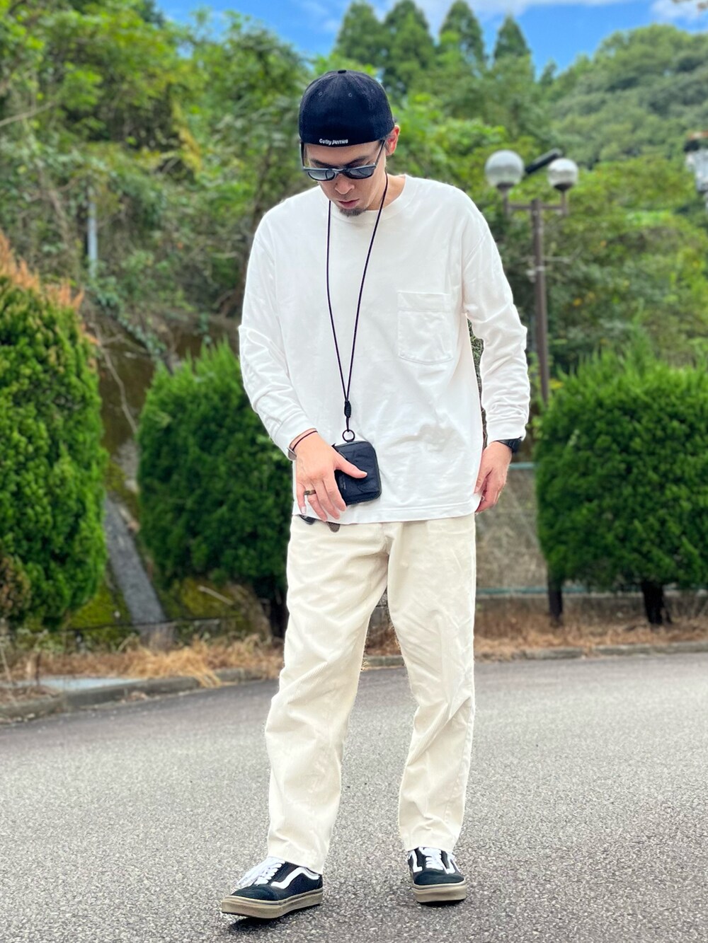 ホワイト系のTシャツ/カットソー、ホワイト系のパンツ、ブラック系のスニーカーを着用したメンズの秋コーディネートの5枚目の写真