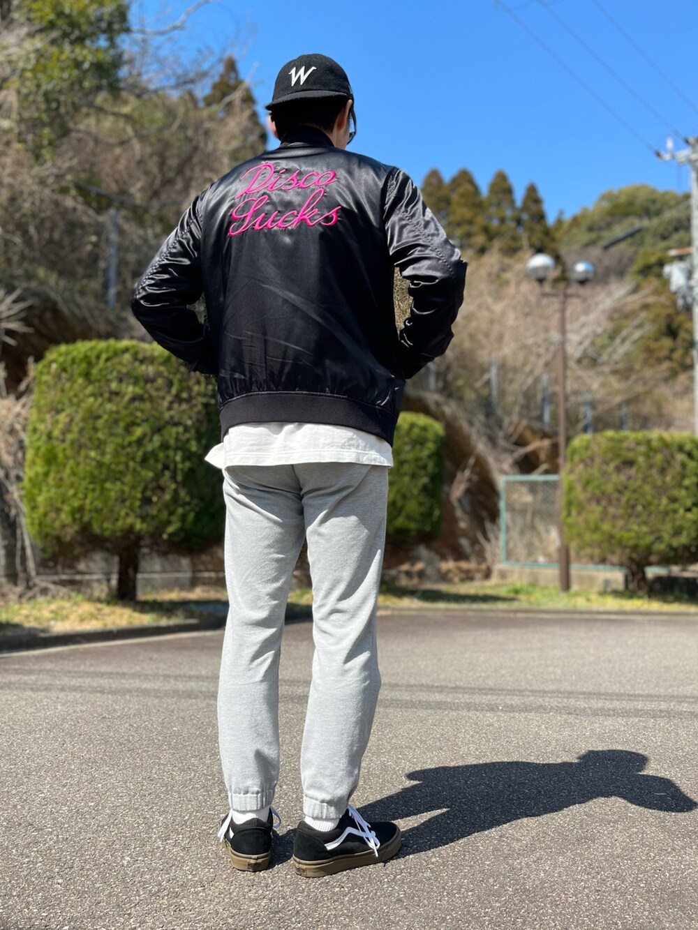 ホワイト系のTシャツ/カットソー、ブラック系のブルゾン、グレー系のスウェットパンツを着用したメンズの春コーディネートの2枚目の写真