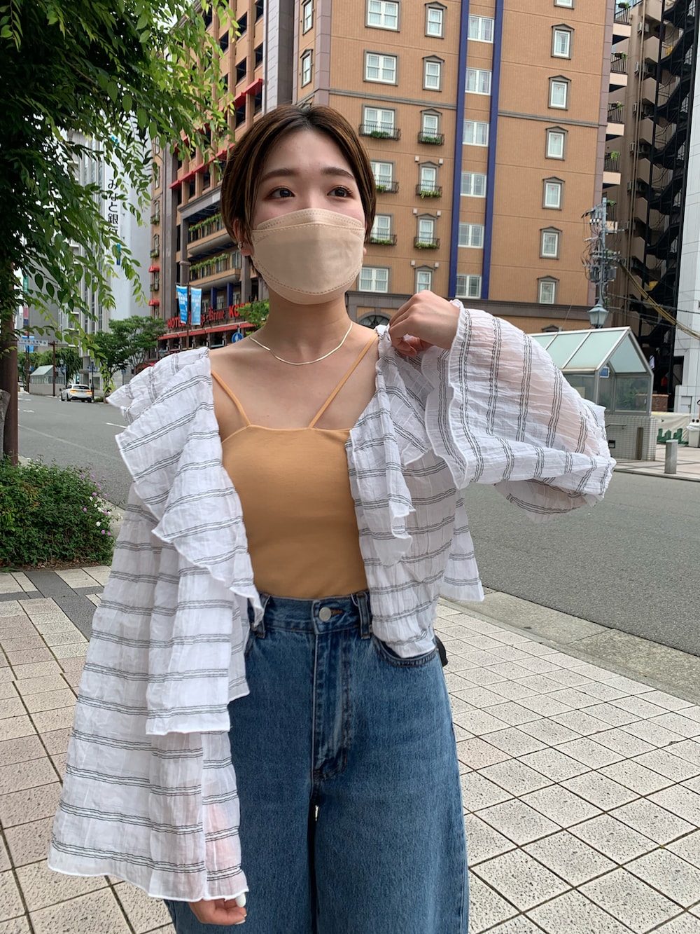 ホワイト系のシャツ/ブラウス、ブルー系のデニムパンツ、ブラウン系のサンダルを着用したレディースの夏コーディネートの2枚目の写真