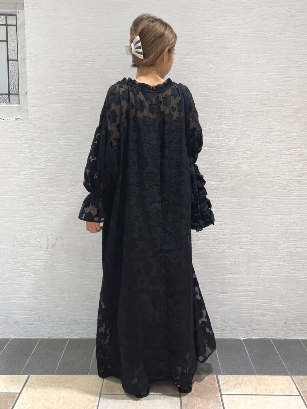 ブラック系のワンピース、ブラック系のパンプス、ブラック系のトートバッグを着用したレディースの春コーディネートの2枚目の写真