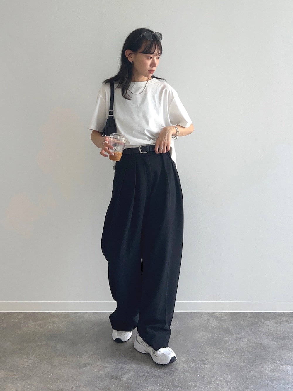 ホワイト系のTシャツ/カットソー、ブラック系のその他パンツ、ホワイト系のスニーカーを着用したレディースの夏コーディネートの2枚目の写真