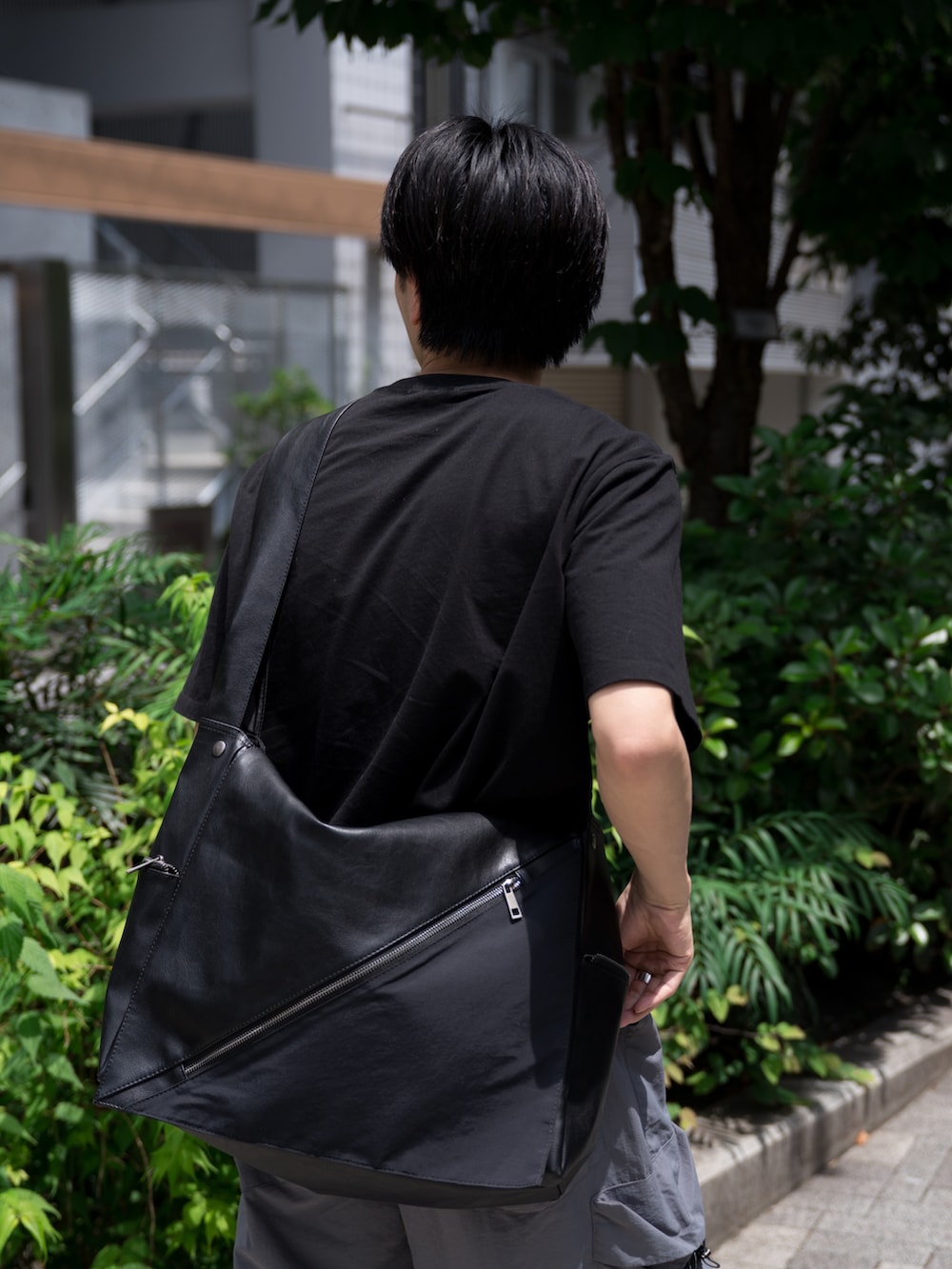 「ショルダーバッグ、夏コーデ、ワイドパンツ、カーゴパンツ、PUMA、黒Tシャツ、タックイン、シンプル、初夏コーデ、カジュアルコーデ」｜「WYM LIDNMのEXTRA FINE COTTON BASIC TEE -SLIM CROPPED FIT-（Tシャツ/カットソー、ブラック系）」を使った、KAIさん（メンズ・183cm）の春コーディネートの5枚目の写真