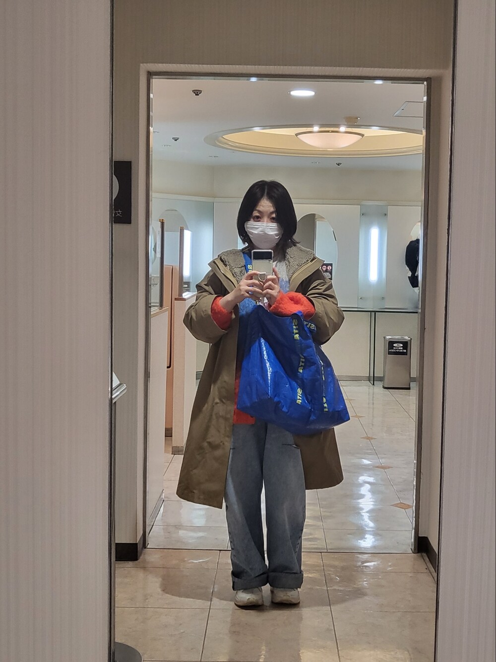 その他のカーディガン/ボレロ、ホワイト系のスニーカー、ブルー系のトートバッグを着用したレディースの冬コーディネートの2枚目の写真