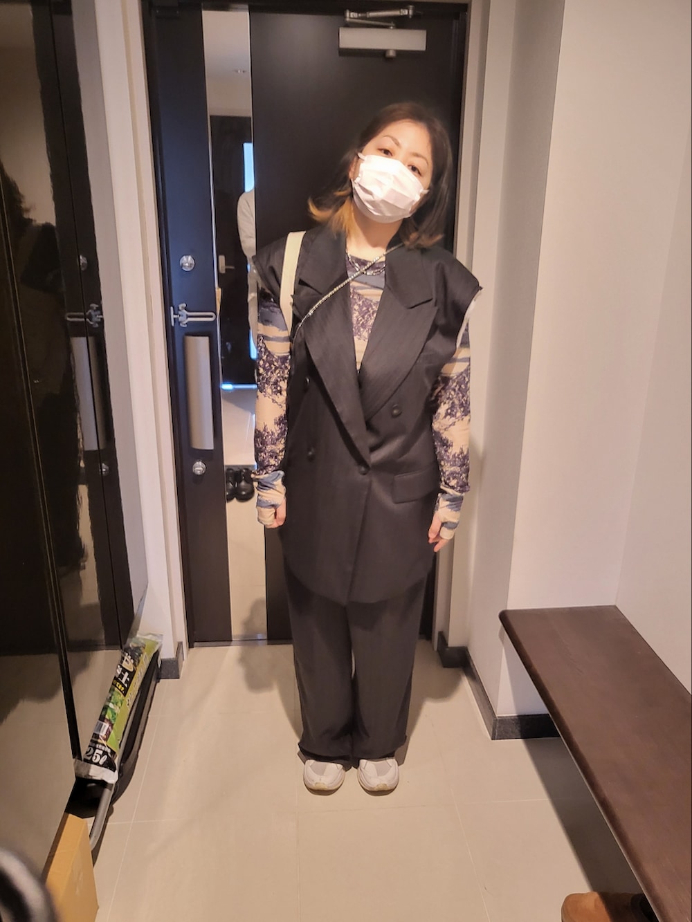 ブラック系のスラックス、ベージュ系のTシャツ/カットソー、ブラック系のその他アウターを着用したレディースの春コーディネートの3枚目の写真