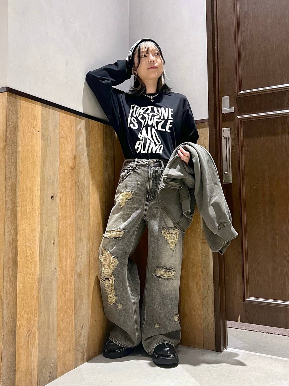 ブラック系のデニムパンツ、ブラック系のTシャツ/カットソー、グリーン系のパーカーを着用したレディースの秋コーディネートの5枚目の写真