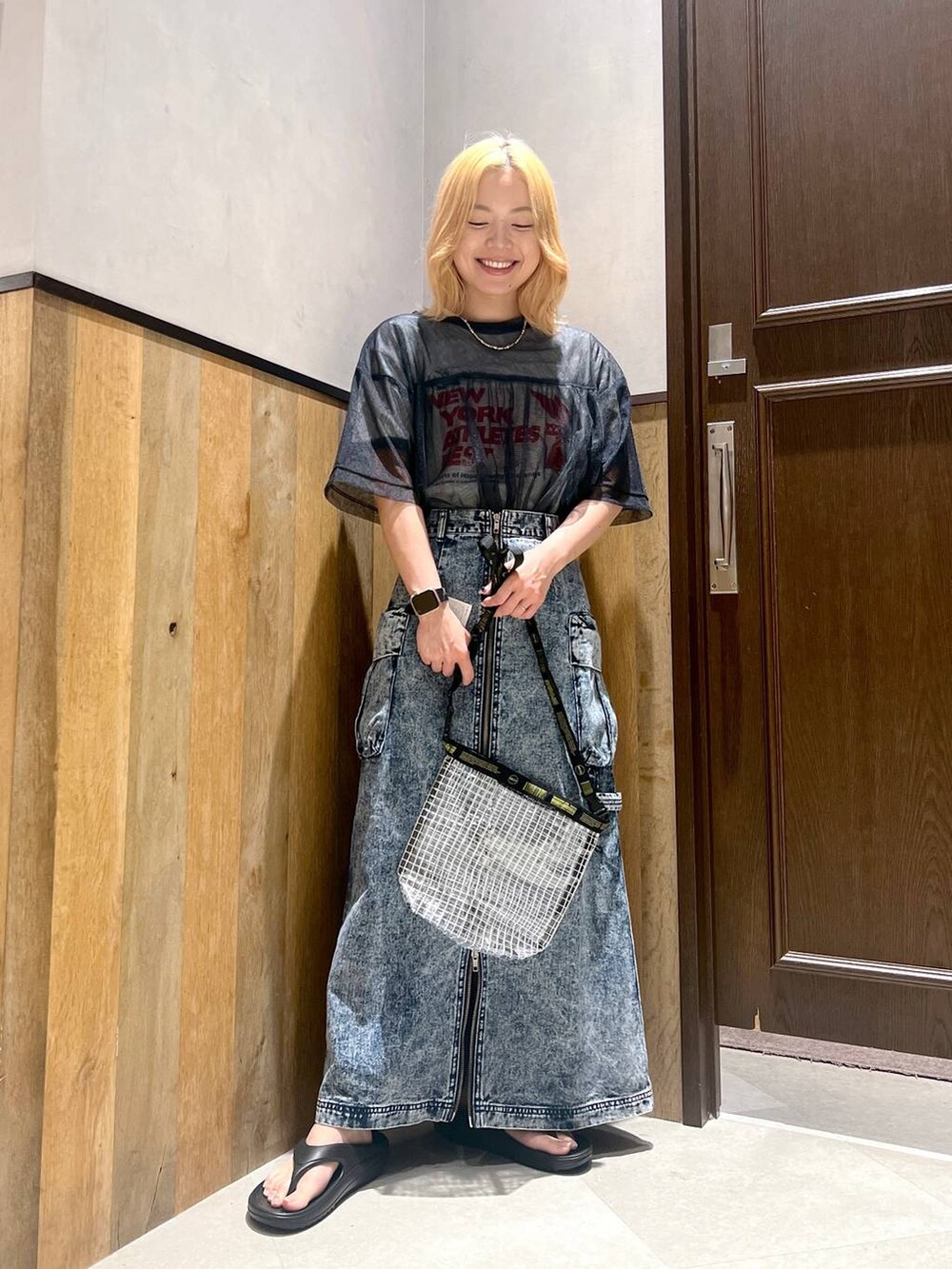 ブラック系のサンダル、ホワイト系のTシャツ/カットソー、ブルー系のデニムスカートを着用したレディースの夏コーディネートの5枚目の写真