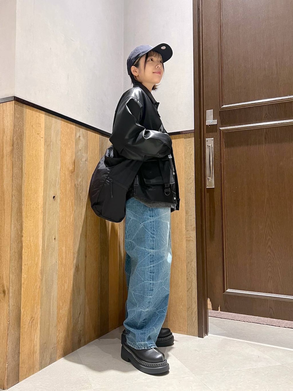 ブラック系のショルダーバッグ、ブラック系のブルゾン、ブラック系のローファーを着用したレディースの秋コーディネートの5枚目の写真